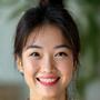 Sarah Chen, 42, smiling contentedly